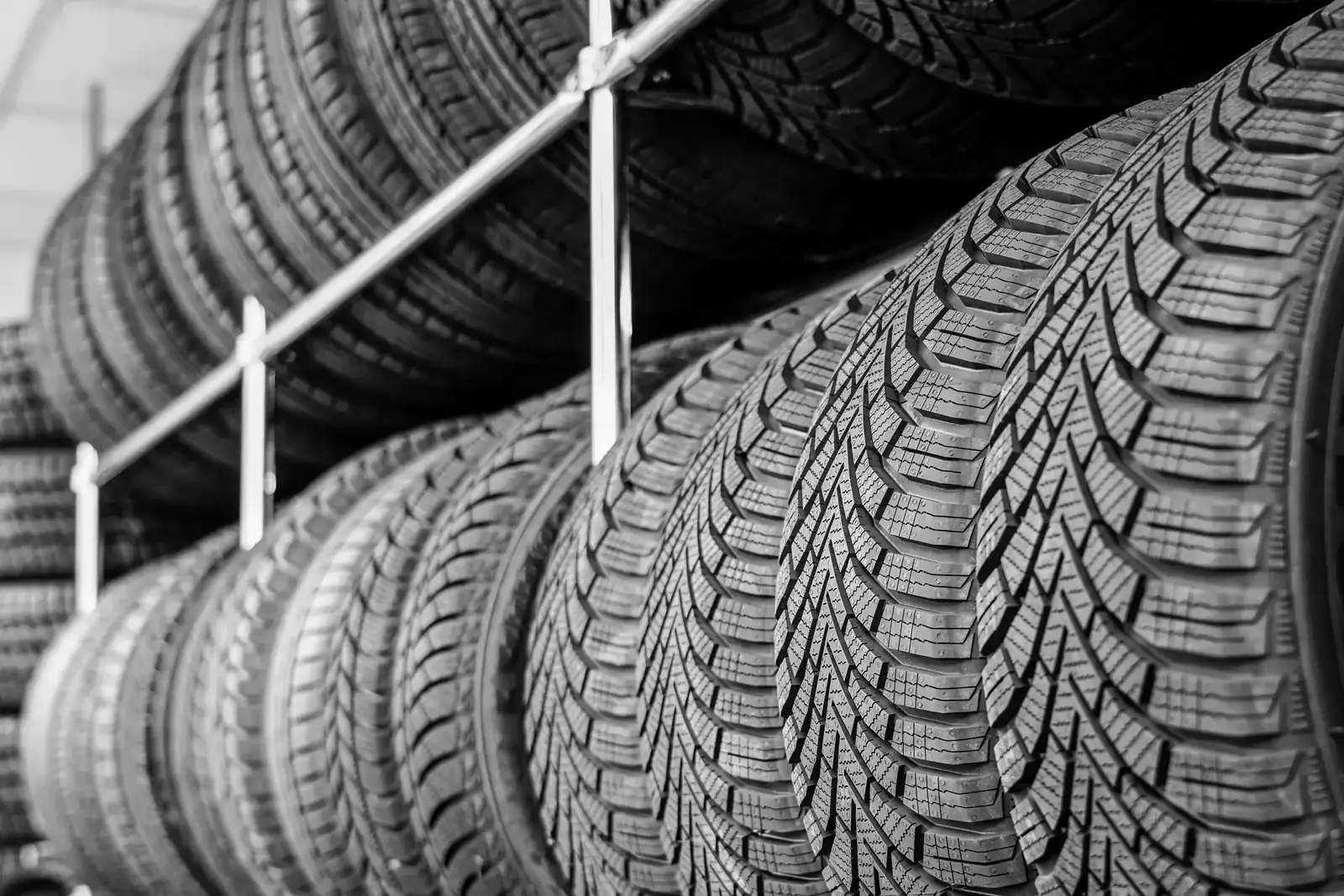 Rows of new tires on a warehouse rack
